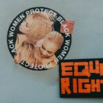 A mural advocating for black women's rights alongside a bold 'Equal Rights' sign.