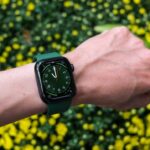 a person's arm with a green apple watch on it