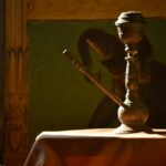 brass-colored teapot on table