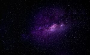 Immersive view of the Milky Way galaxy with vibrant purple hues under a clear night sky. Immersive view of the Milky Way galaxy with vibrant purple hues under a clear night sky.