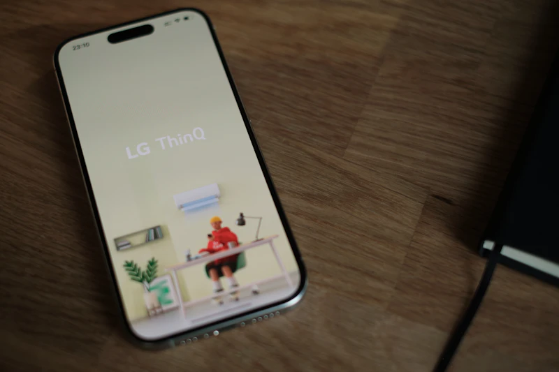 A cell phone sitting on top of a wooden table
