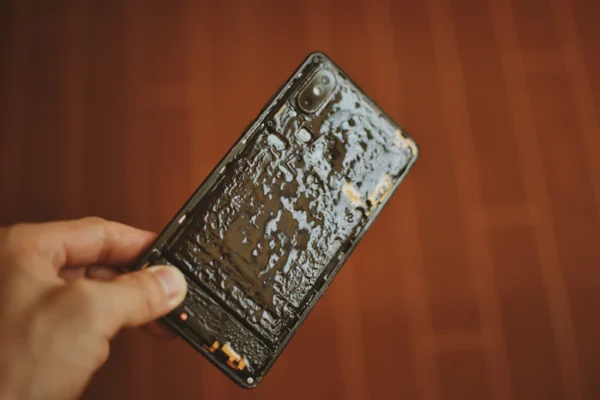 a person holding a cell phone in their hand