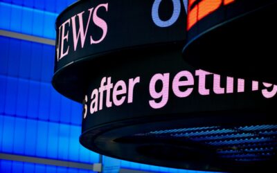 a close up of a sign with a building in the background