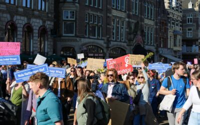 Crowd of people holding signs at a protest.