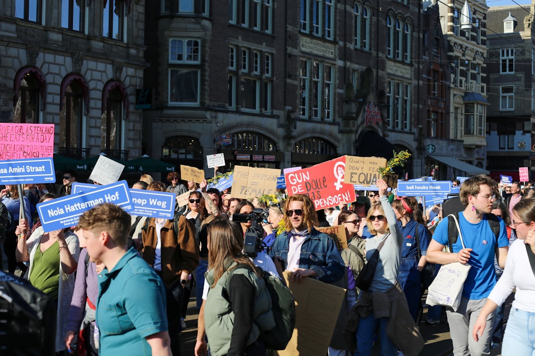Crowd of people holding signs at a protest.