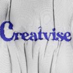 A close up of a white shirt with blue writing on it