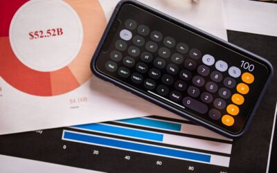 A smartphone displaying a calculator app on financial charts, showcasing revenue analysis.
