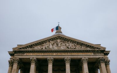 A tall building with a flag on top of it