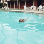 woman in swimming pool during daytime