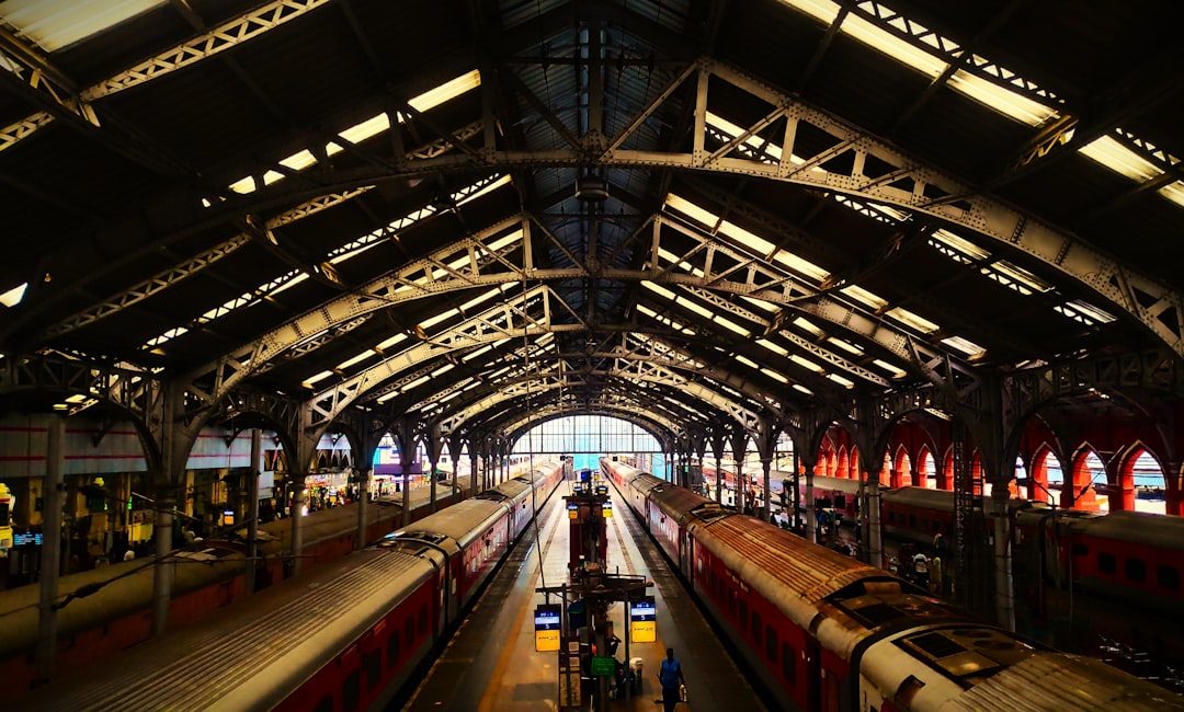 Two trains at a grand, historic train station.