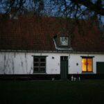 a white house with a red roof and windows
