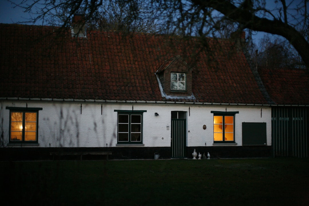a white house with a red roof and windows