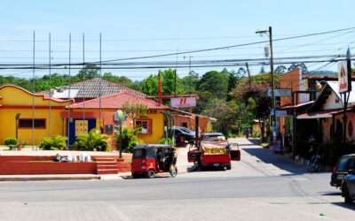 red and black cars on road near brown building during daytime