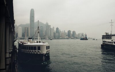 A couple of boats floating on top of a large body of water