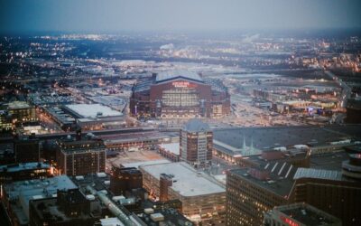 Captivating aerial view of Lucas Oil Stadium and Indianapolis cityscape at dusk.