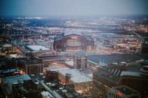 Captivating aerial view of Lucas Oil Stadium and Indianapolis cityscape at dusk.