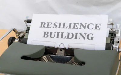 a typewriter with a sign that reads resilince building