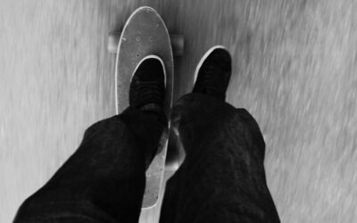 a person riding a skateboard down a street
