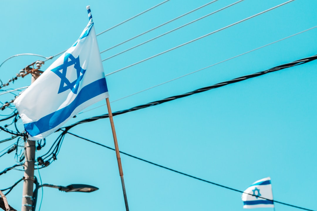 the israeli flag is flying on a pole