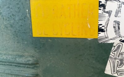 a close up of a street sign with a yellow sticker