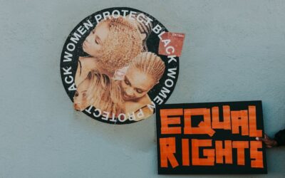 A mural advocating for black women's rights alongside a bold 'Equal Rights' sign.