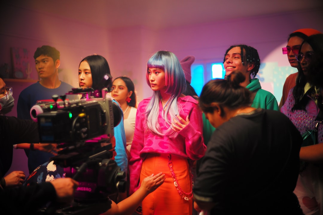 a group of people standing around a camera