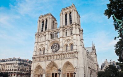 Architectural beauty of Notre Dame Cathedral with crowds in Paris, France.