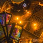 a table topped with cards and candles on top of a blanket