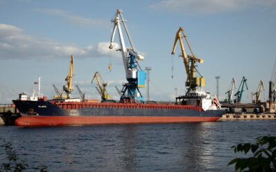 A cargo ship docks at a busy port.