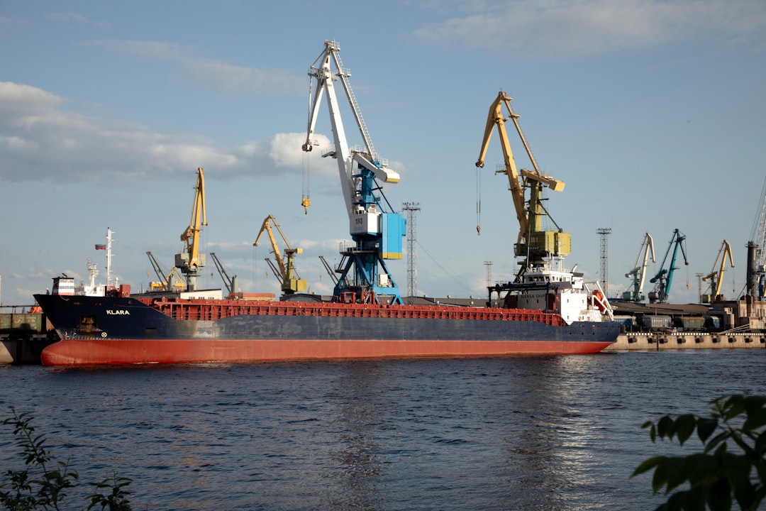 A cargo ship docks at a busy port.