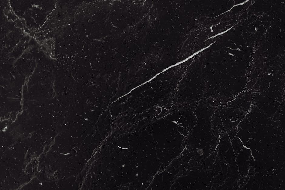 Sophisticated black marble texture with natural veining ideal for backgrounds and design projects.