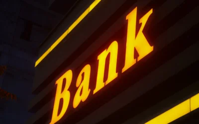 a bank sign lit up in the dark