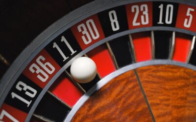 Detailed view of a roulette wheel with a ball, emphasizing the excitement of gambling.
