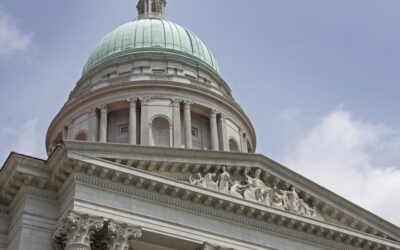 the dome of a building with statues on it