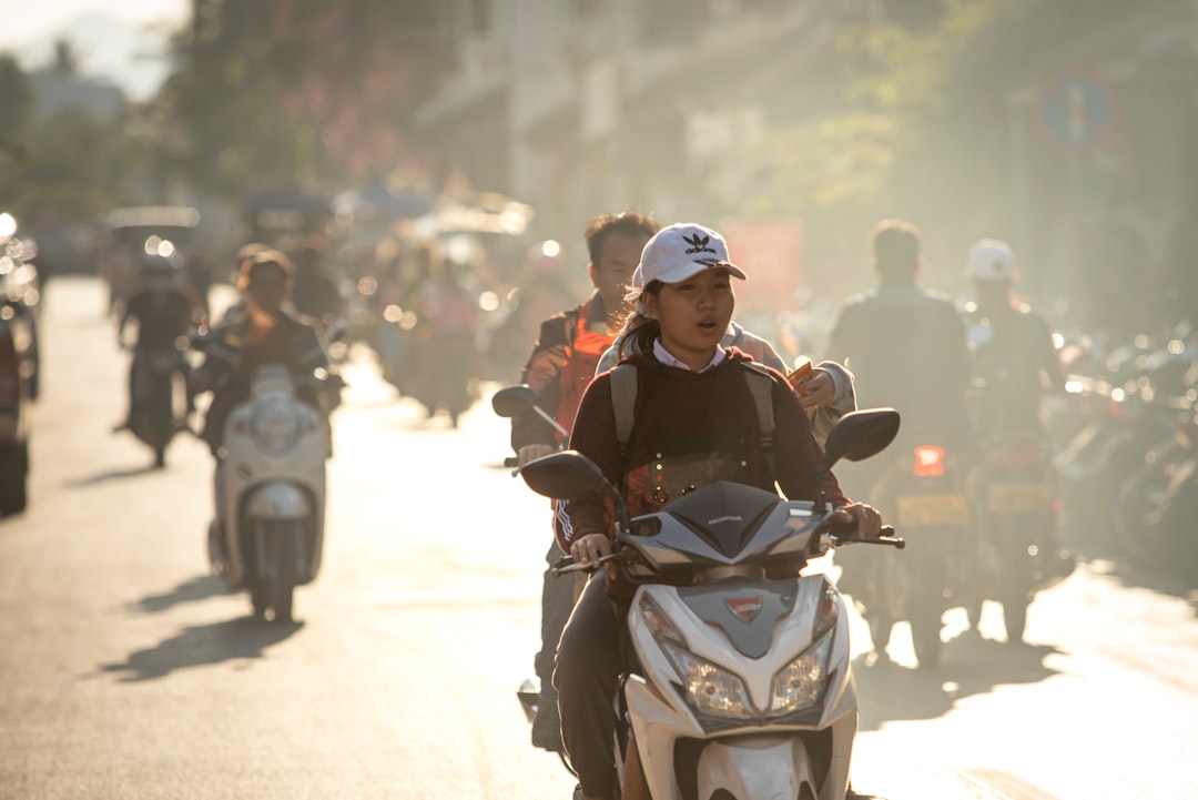 A group of people riding motorcycles down a street
