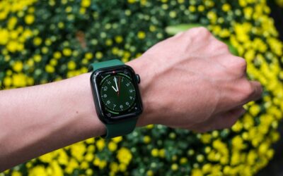 a person's arm with a green apple watch on it