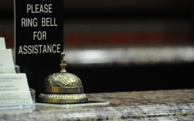 gold bell on brown wooden table
