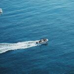 A small boat traveling across a large body of water