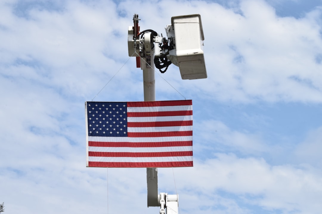 American flag on a pole with security camera.
