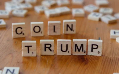 Scrabble tiles spelling 'TRUMP' on a wooden table, creating a political theme.
