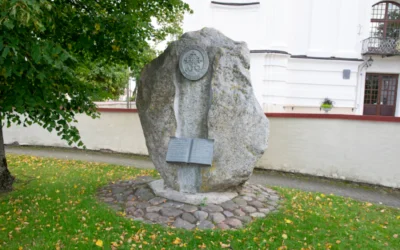 a large rock with a book on it in the grass