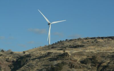 a wind turbine on top of a hill