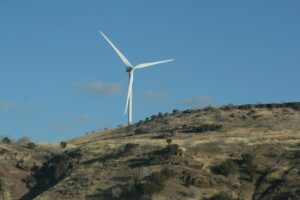 a wind turbine on top of a hill