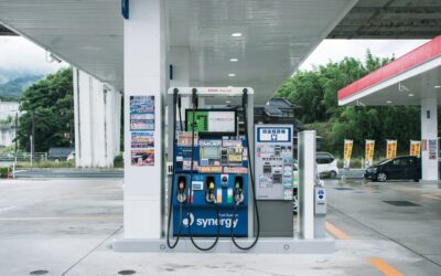 a gas station with a gas pump in the foreground