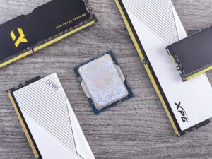 Detailed shot of DDR5 RAM modules and a CPU on a wooden table, highlighting computer hardware.