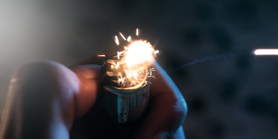 A macro shot showing a lighter being lit, with vibrant sparks in motion.