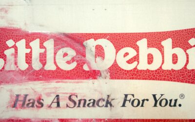 a red and white sign that says little pebble has a snack for you