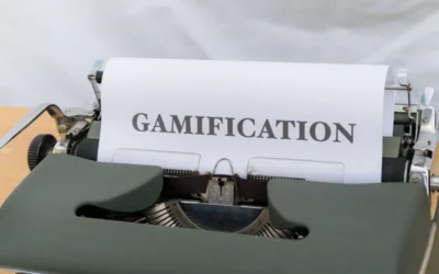 a close up of a typewriter with a paper that reads gamification