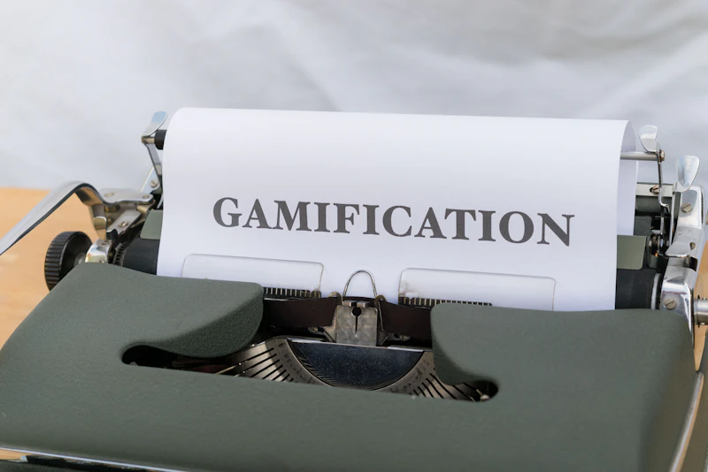 a close up of a typewriter with a paper that reads gamification