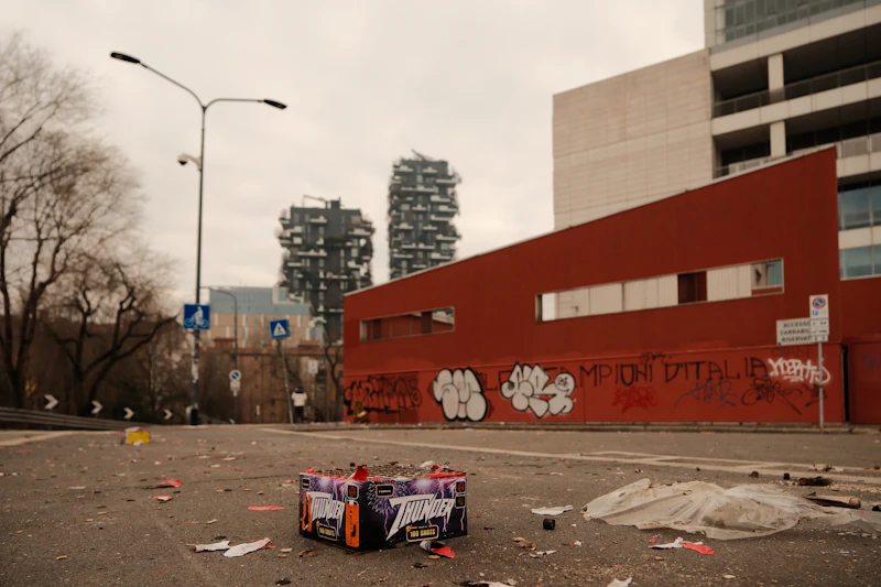 City street with modern buildings and trash.